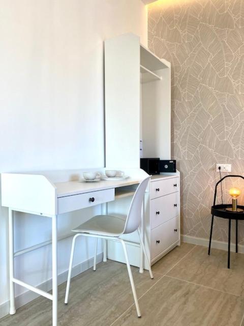 a white desk with a chair and a dresser in a room at Le Calette House - Puglia Mia Apartments in Monopoli