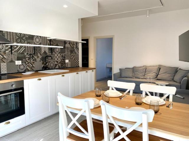 a kitchen with a table and chairs and a couch at Le Calette House - Puglia Mia Apartments in Monopoli