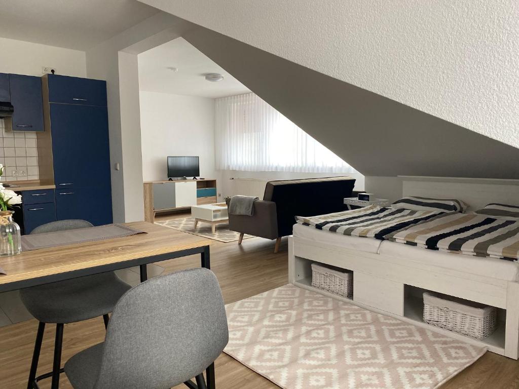 Habitación con cama, mesa y sillas. en Appartement 5 in Hilter en Hilter am Teutoburger Wald