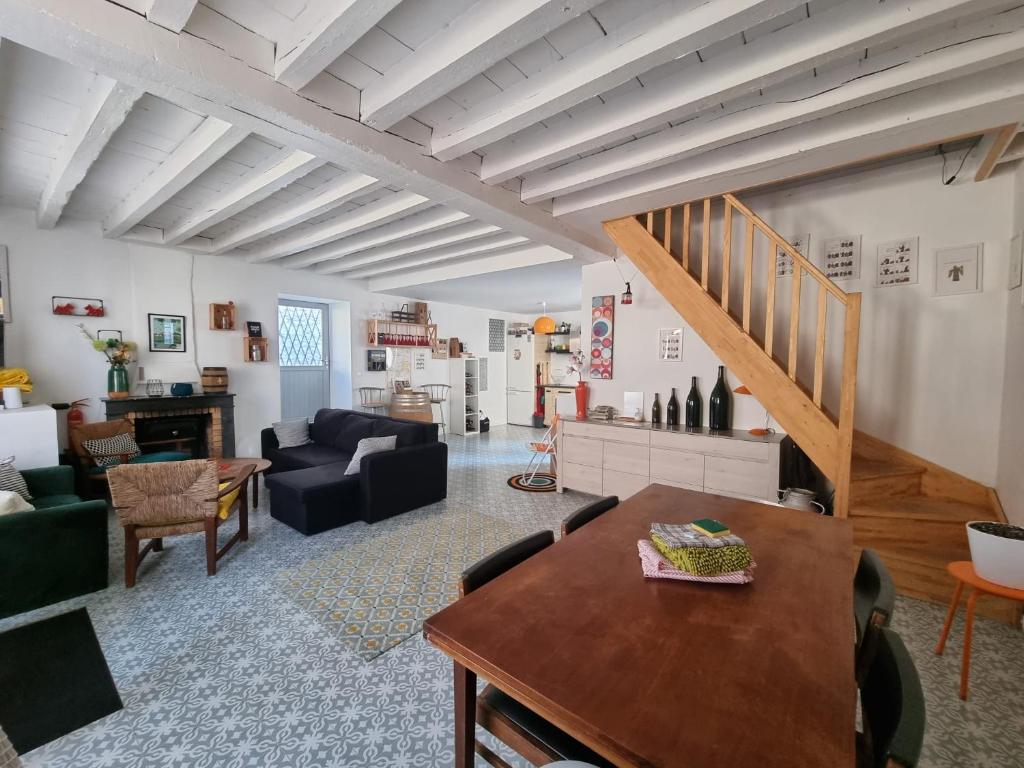 a living room with a couch and a table at Maison avec terrasse au coeur de Sancerre in Sancerre