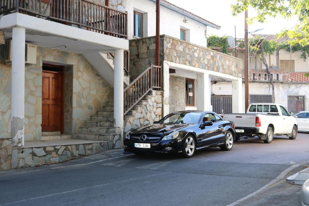 a black car parked in front of a building at Tsangaris House in Action in Limassol