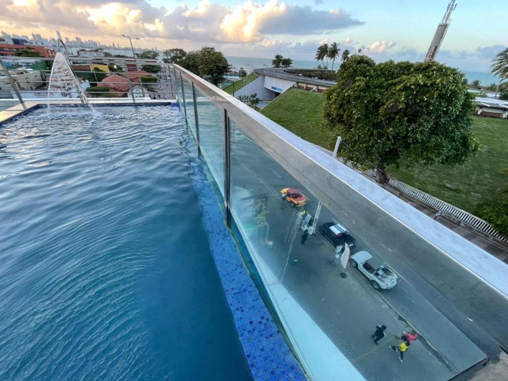 an overhead view of a swimming pool with water at Apt 219 in João Pessoa