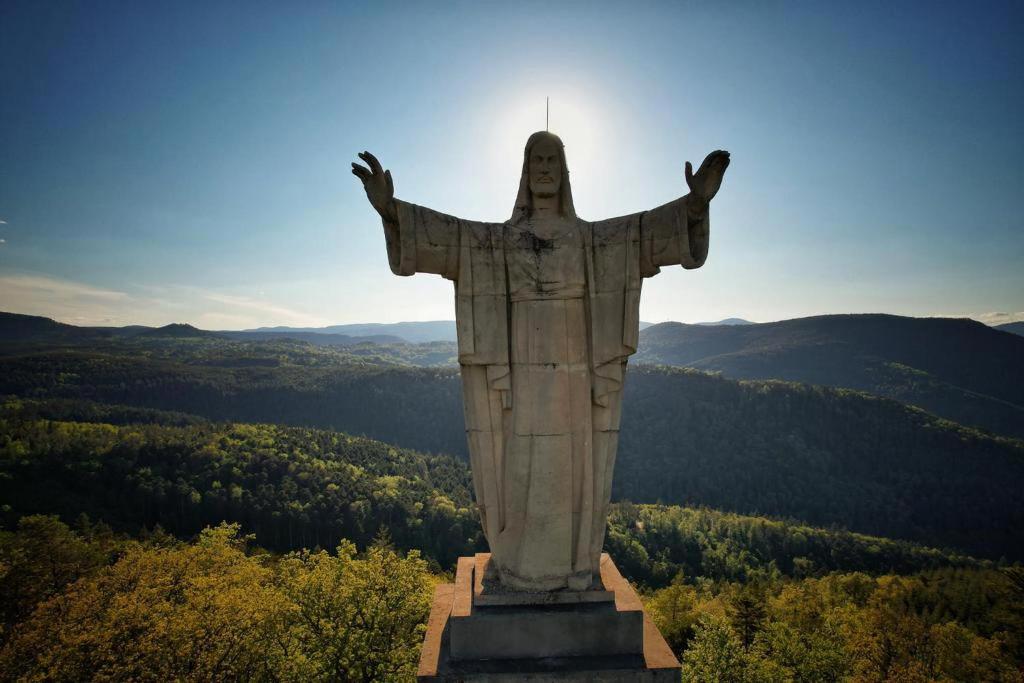 a statue of christ the redeemer on top of a mountain at Le Petit Pèlerin in Ammerschwihr