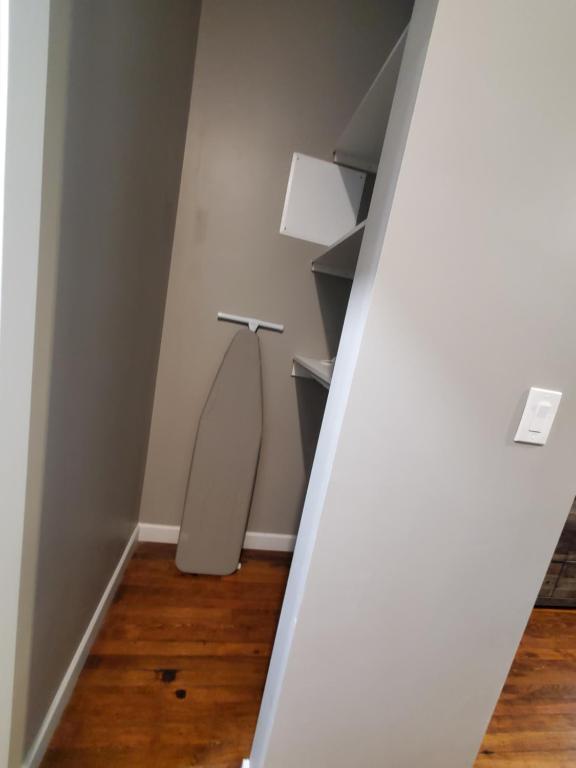a room with a white wall with a lamp at Trendy Midtown Loft in Cleveland