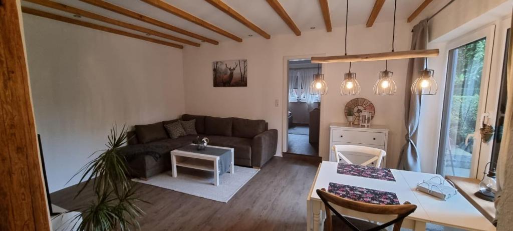 a living room with a couch and a table at Ferienwohnung Spessartbude in Schollbrunn