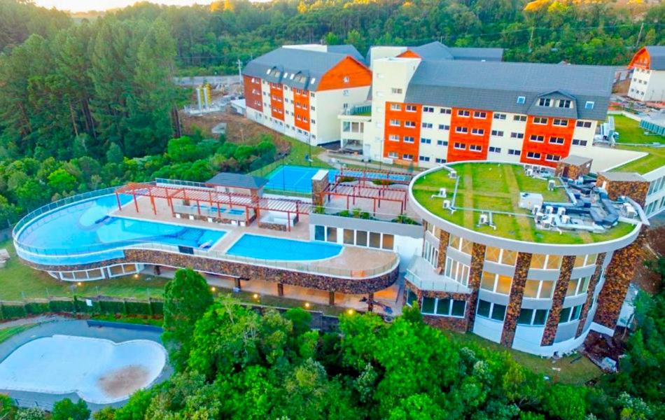 an aerial view of a building with a swimming pool at Apartamento - Golden Laghetto Resort Gramado in Gramado