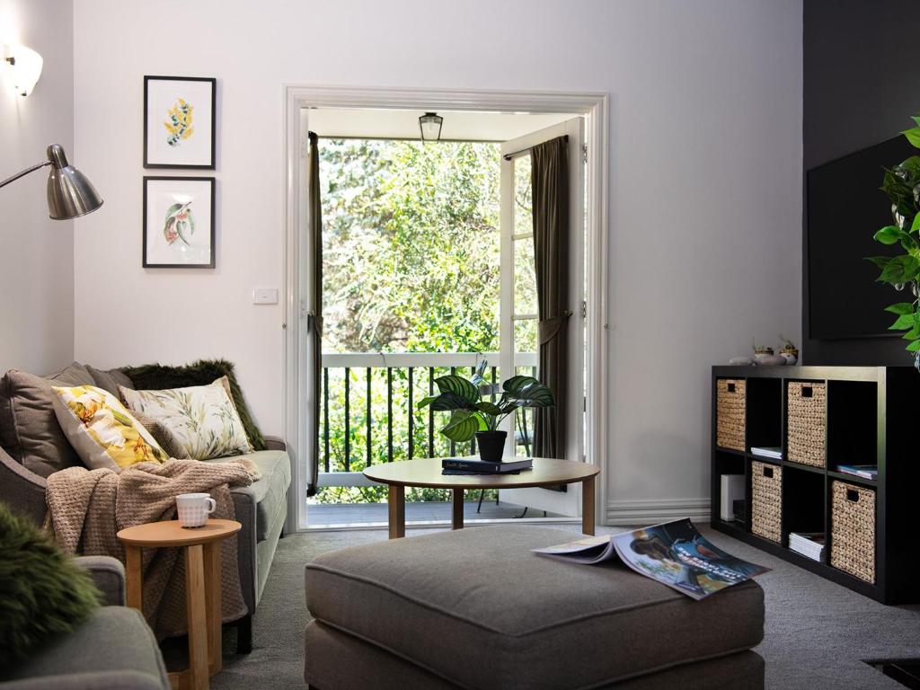 a living room with a couch and a table at Lucini Cottage in Hepburn Springs