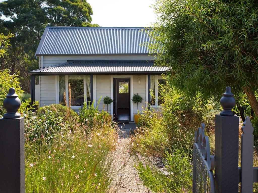 a small white house with a metal roof at Koovelly Spa in Hepburn