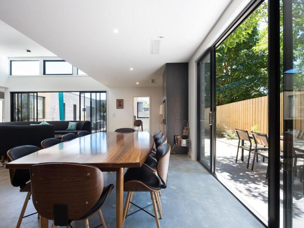 a dining room with a wooden table and chairs at Arenas South- 3 bedroom, 2 bathroom home in Daylesford