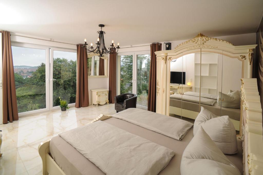 a bedroom with a large bed with a large mirror at Designlofts 14P - Sennhütte 17 in Wernigerode