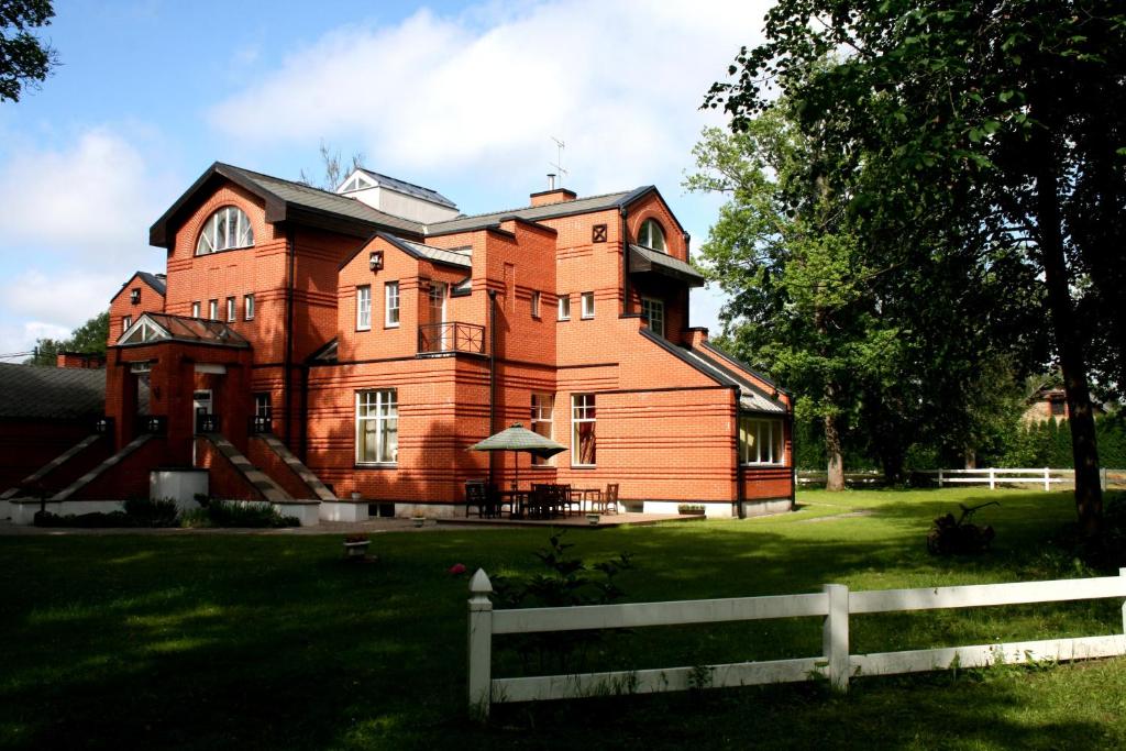 
a large brick building with a red roof at Villa Alberta in Sigulda
