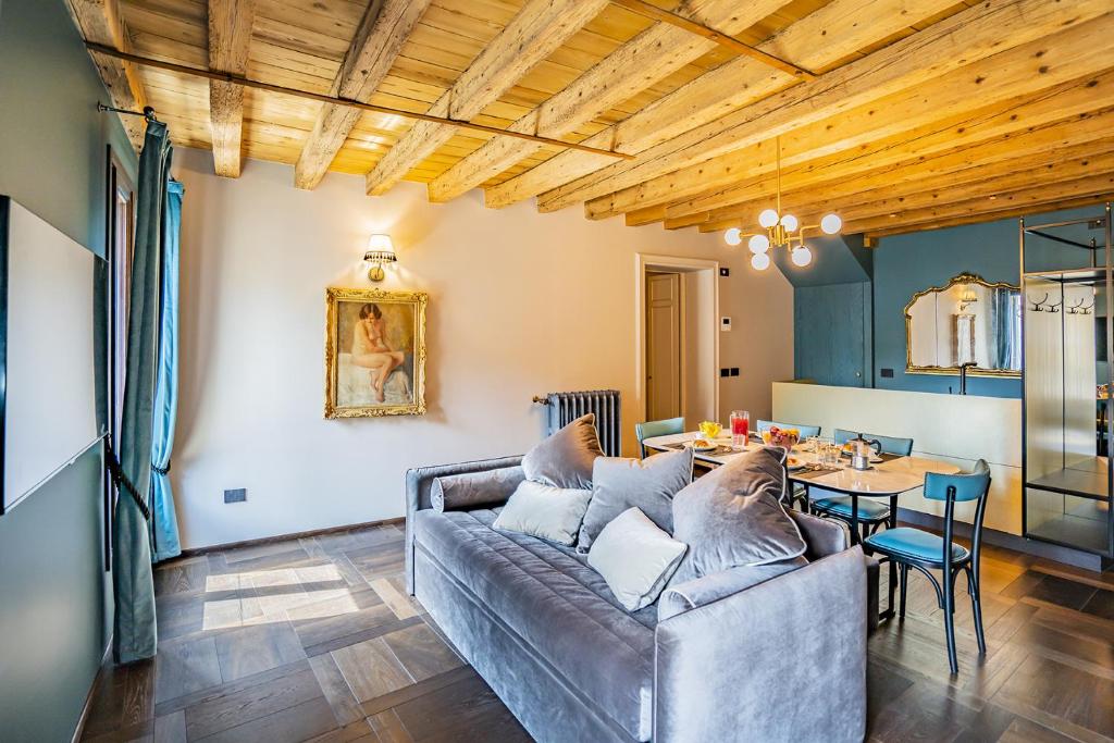 a living room with a couch and a table at Corte Rubbi 9 Canal View -Dimora Italia Selection- in Venice