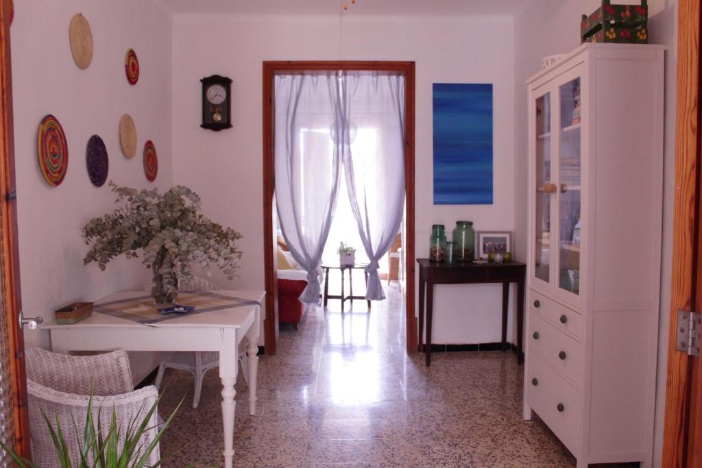 a living room with a table and a window at Casa Marina in Colonia Sant Jordi