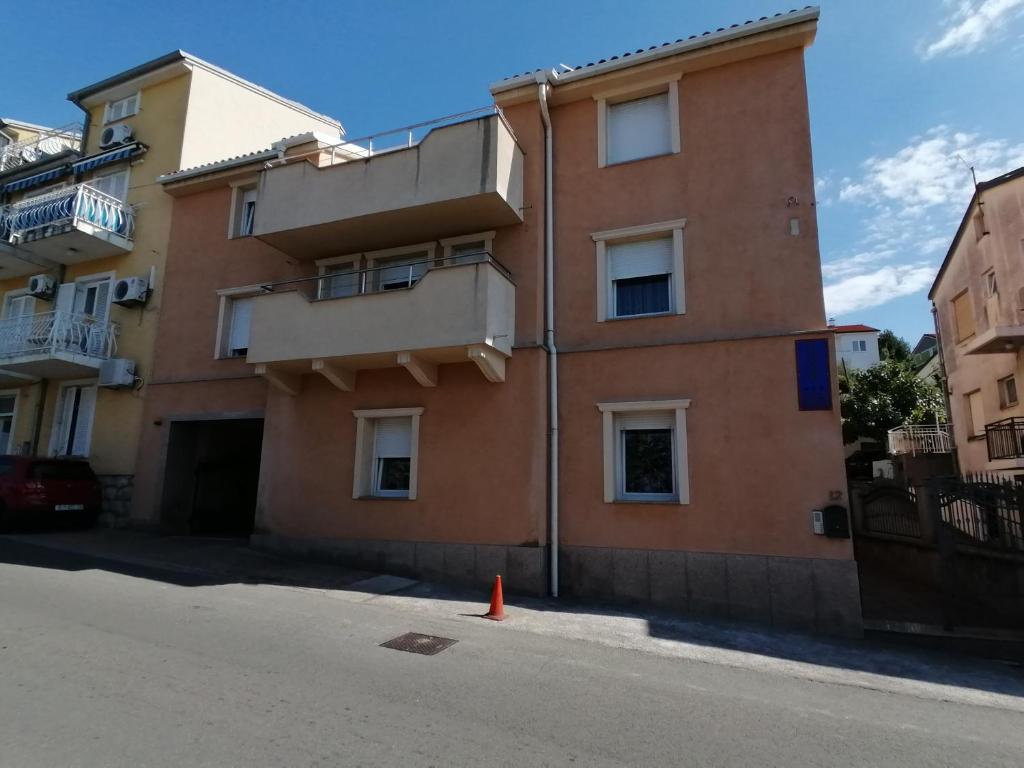 an apartment building with an orange cone in front of it at Apartmani Golomeić in Crikvenica