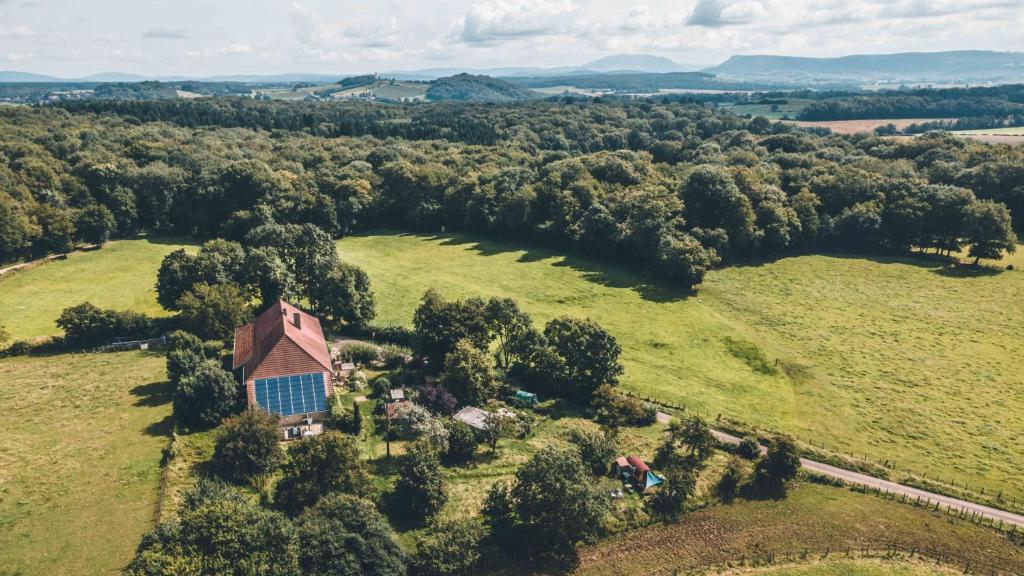 an aerial view of a farm with a barn and trees at GITE COEUR DE NATURE in Abergement-le-Grand