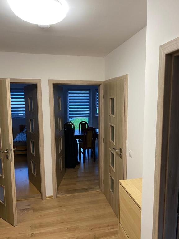 a kitchen and dining room with two doors and a table at W apartmán 2 in Teplice nad Metují