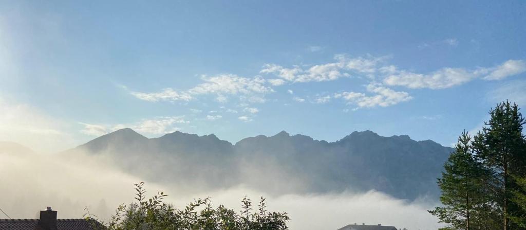 a view of a mountain range in the clouds at Unser Dahoam in Wallgau