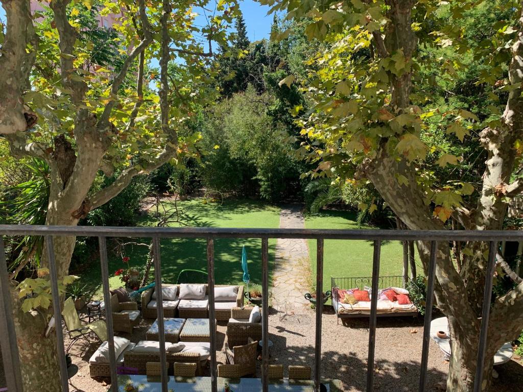 a view of a garden with chairs and a tree at Le Transvaal-Maison d'Hôtes in Marseille