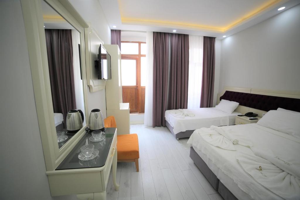 Säng eller sängar i ett rum på taksim diamond hotel