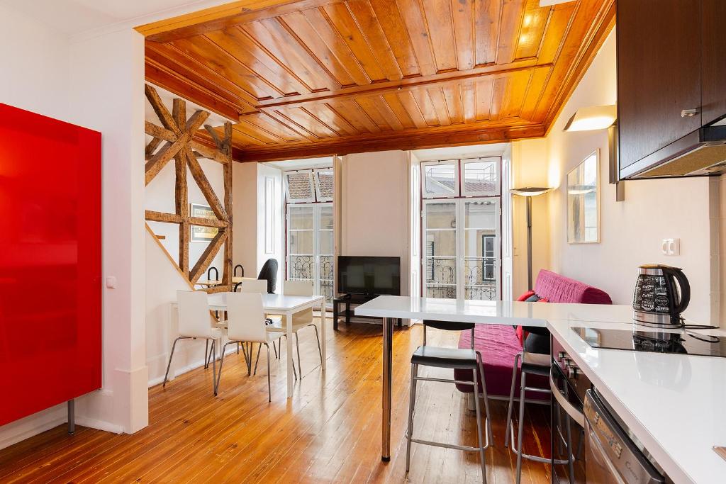 a kitchen and living room with a table and chairs at Alfama First Floor in Lisbon