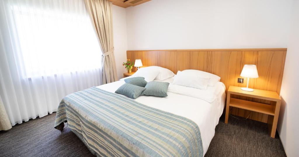 a bedroom with a bed with two pillows on it at Jožef in Idrija