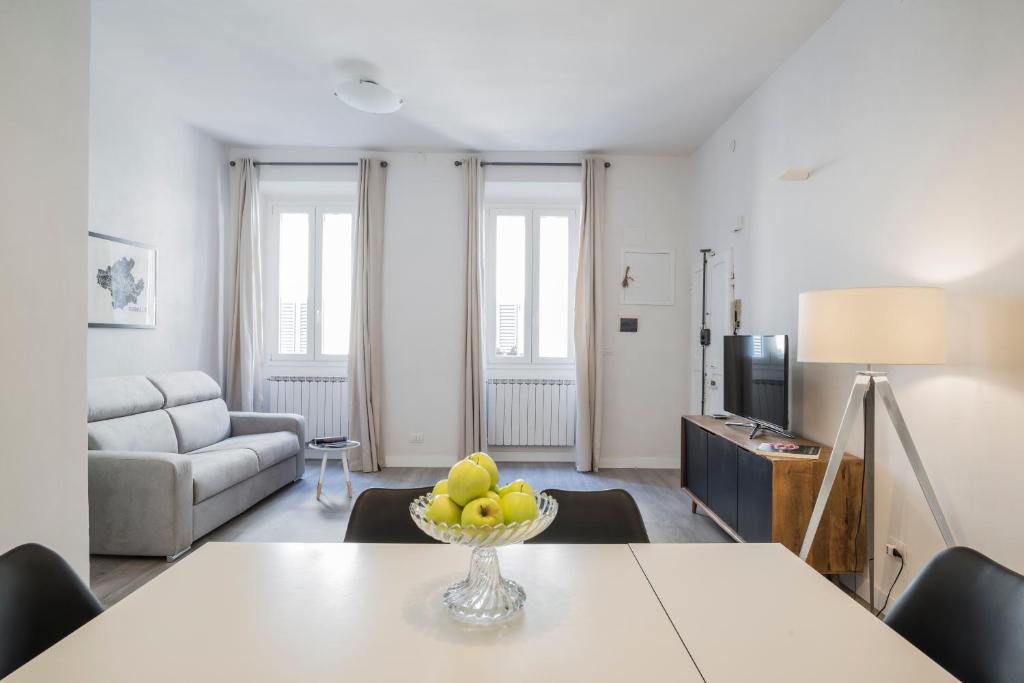 a living room with a table with a bowl of fruit at Apartments Florence - Sant’Ambrogio Passion in Florence