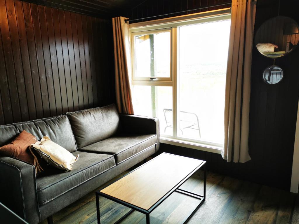 a living room filled with furniture and a window at Karasjok Camping becoming Min Ája in Karasjok