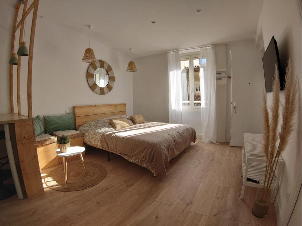 een slaapkamer met een bed en een bank erin bij STUDIO Petite canaille in Cassis
