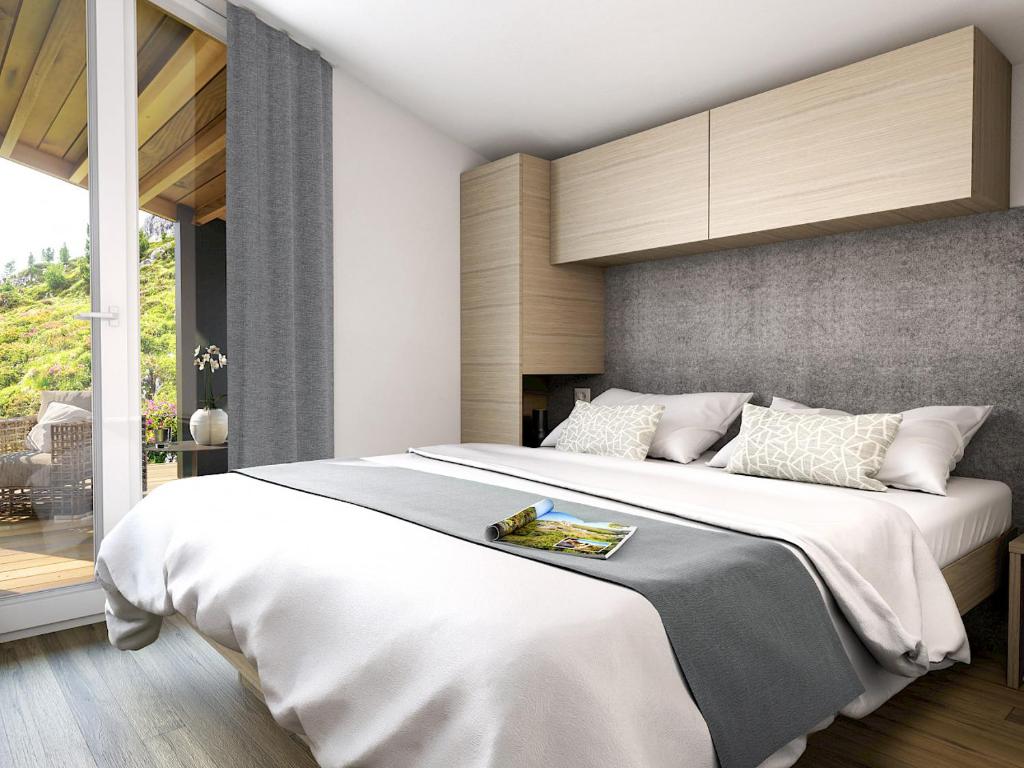 Postel nebo postele na pokoji v ubytování Chalets & Glamping Nassfeld by ALPS RESORTS