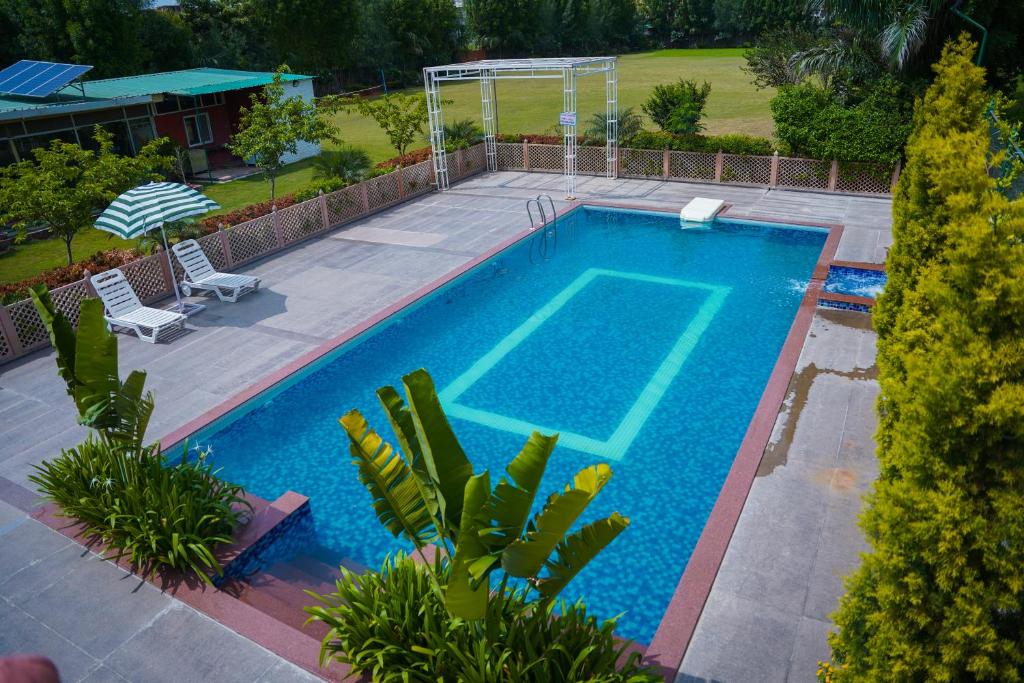 an overhead view of a swimming pool in a yard at Abha Farms and Resort in Udaipur