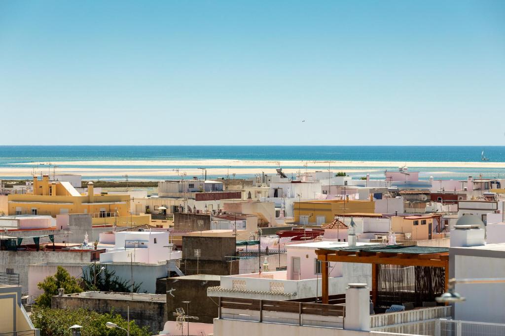 a view of a city with the ocean in the background at Estudios Salinas - Fuseta in Fuzeta