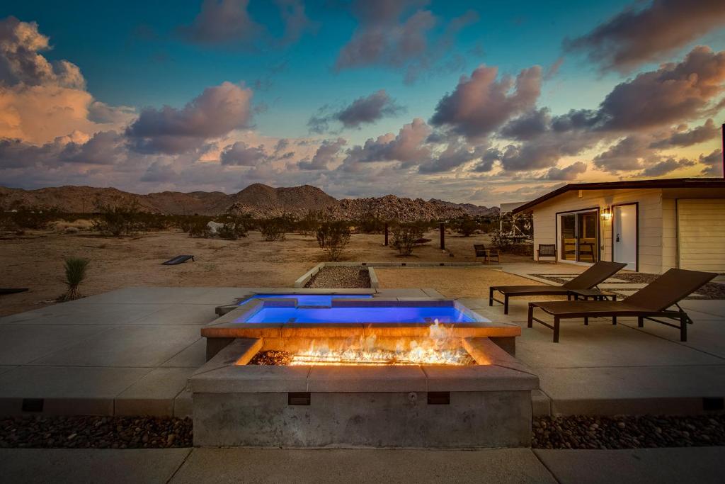 a fire pit in the middle of a patio at @ Marbella Lane - The Moon Designer Home right behind the JTNP in Joshua Tree