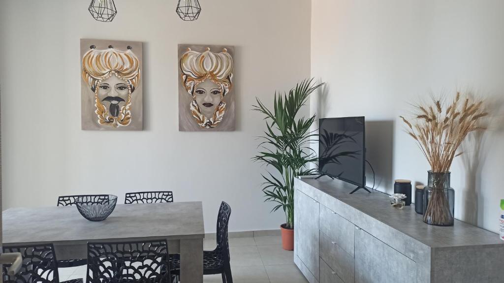 uma sala de jantar com duas cabeças de leão na parede em CasaVera apartment em Acireale