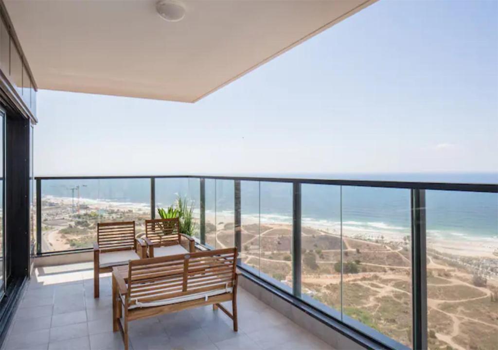 a room with benches and a view of the ocean at O&O Group- Magical 4BR APT With Panoramic Sea View in Bat Yam