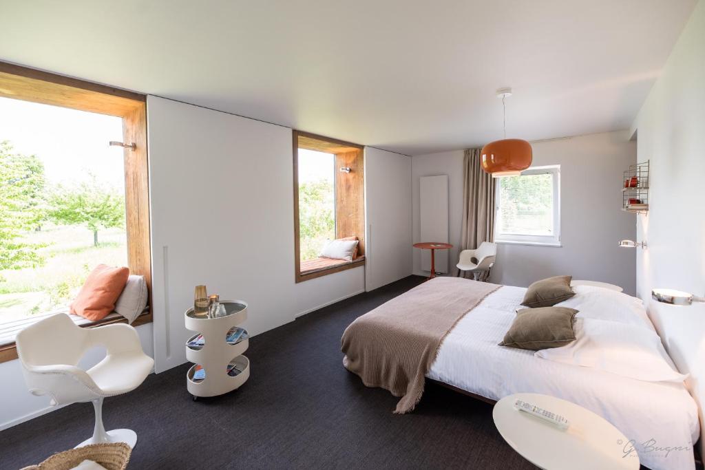 Postel nebo postele na pokoji v ubytování côté verger B&B