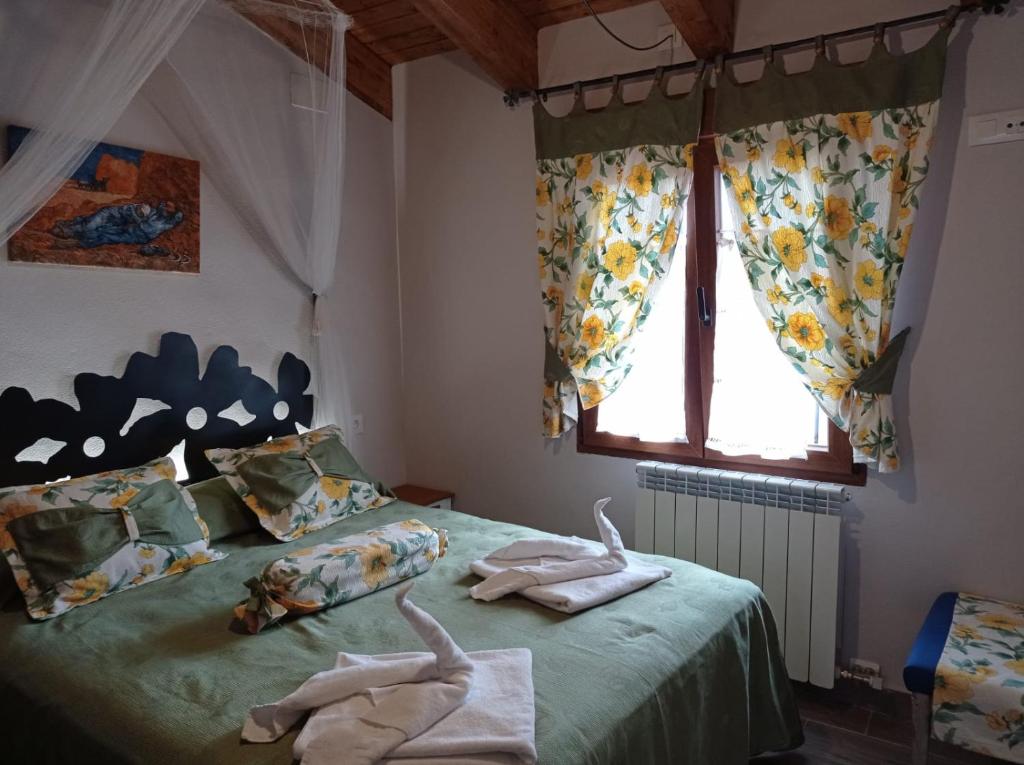 Postel nebo postele na pokoji v ubytování Apartamentos CASA RURAL EL VENTANICO