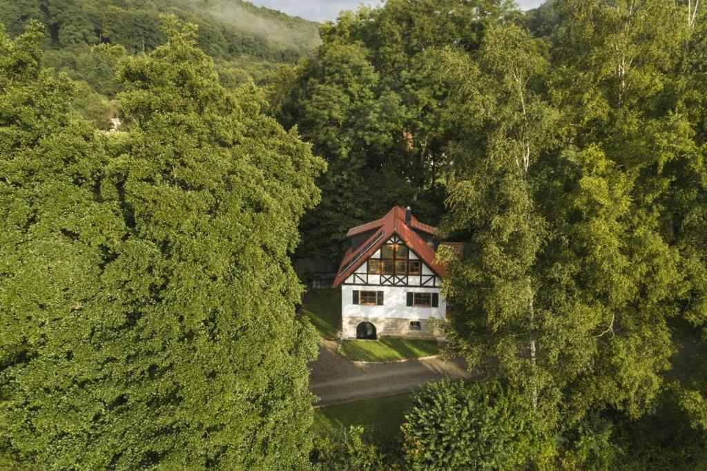 an aerial view of a house in the middle of trees at Ferienhaus Chalet an der Brettach in Gerabronn