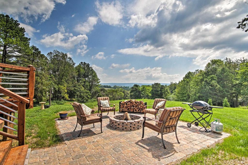 a patio with chairs and a fire pit and a grill at Family Retreat with Deck Near Appalachian Trail! in Berryville