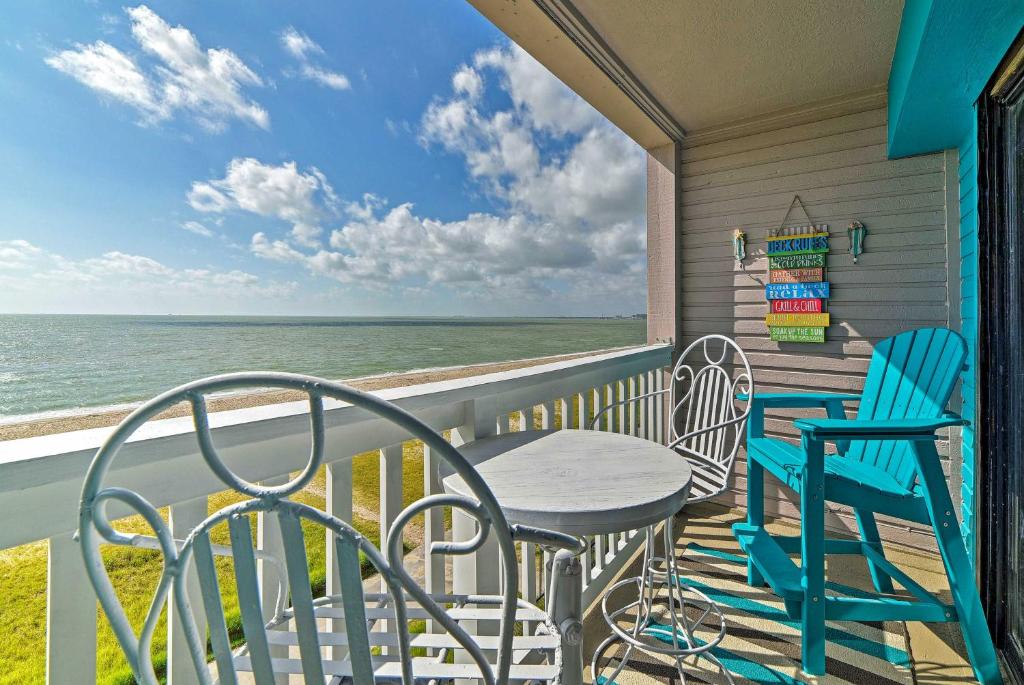 a balcony with a table and chairs and the ocean at Oceanfront Corpus Christi Condo Resort Perks! in Corpus Christi
