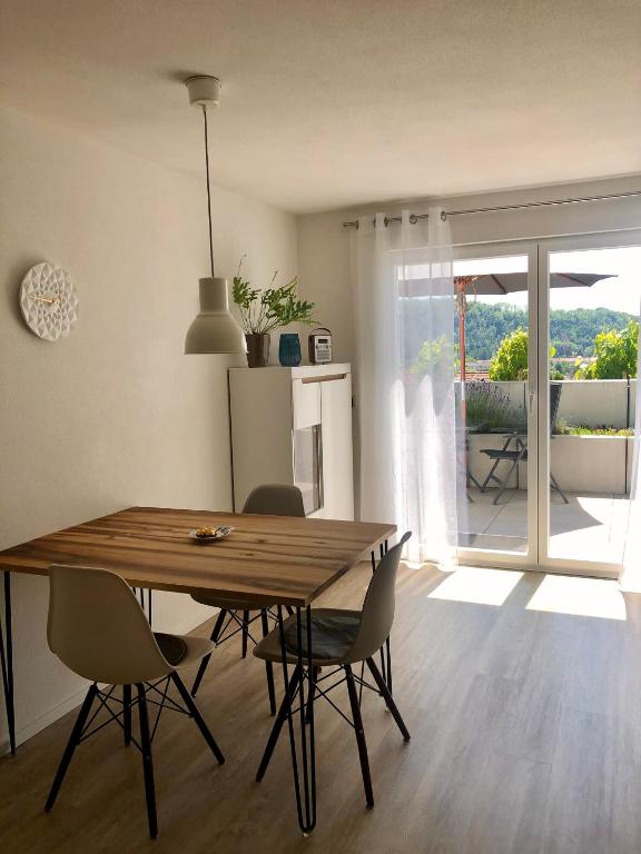 a dining room with a wooden table and chairs at Ferienwohnung no.55 in Lörrach