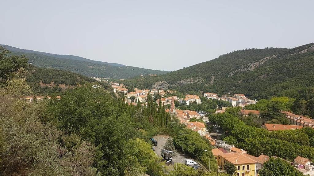 a view of a town in a valley with mountains at Joli studio de 26 m² avec véranda de 6 m² calme et vue sur montagne in Amélie-les-Bains-Palalda