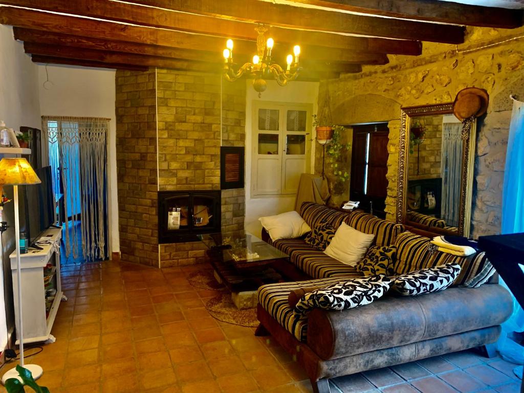 sala de estar con 2 sofás y chimenea en Casa Tatisita III, en Segura de la Sierra