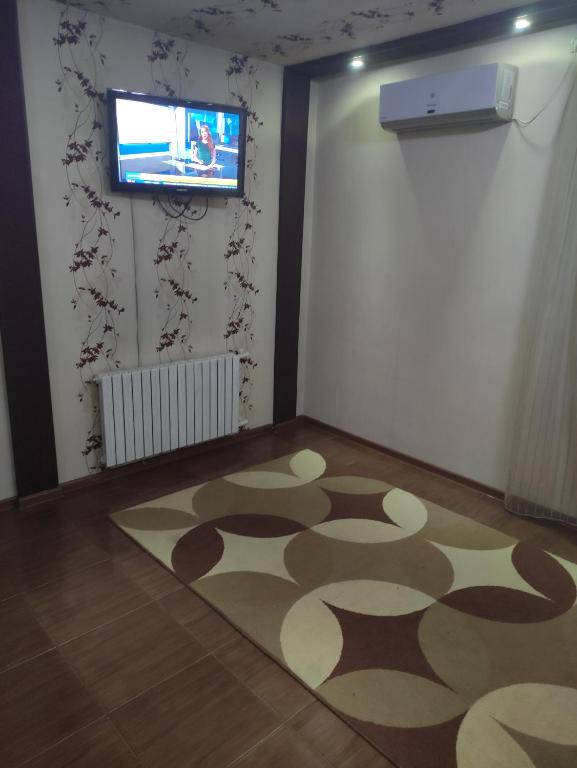 a room with a rug on the floor and a television at EAA in Tiraspol