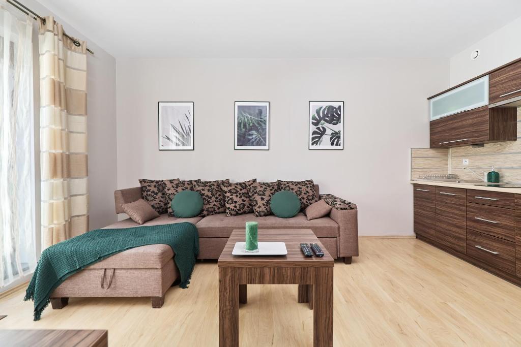 a living room with a couch and a table at Apartment Wrocław Krawiecka by Renters in Wrocław