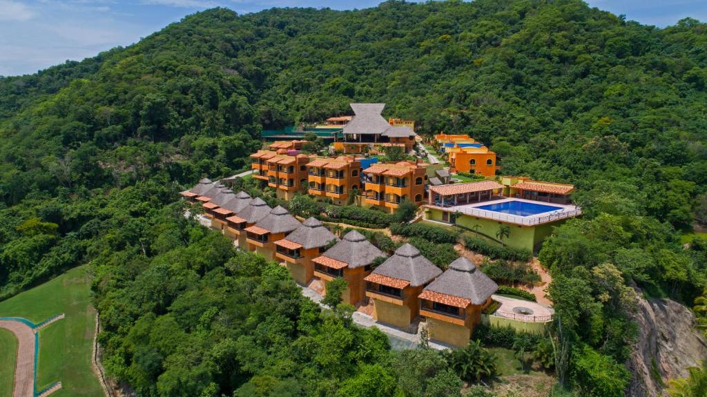 an aerial view of a mansion on a mountain at El Corazón Golf & Spa Resort Manzanillo in Manzanillo