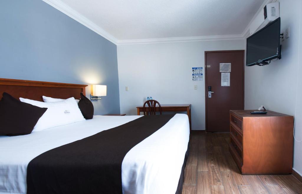 Postel nebo postele na pokoji v ubytování Del Marques Hotel and Suites
