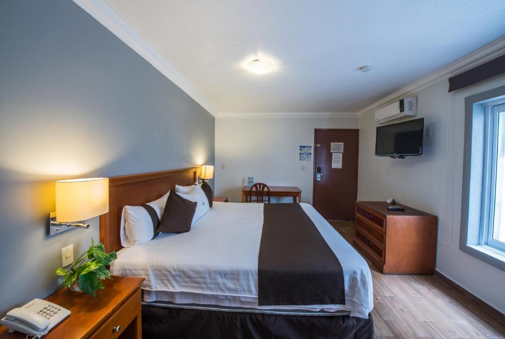 Postel nebo postele na pokoji v ubytování Del Marques Hotel and Suites