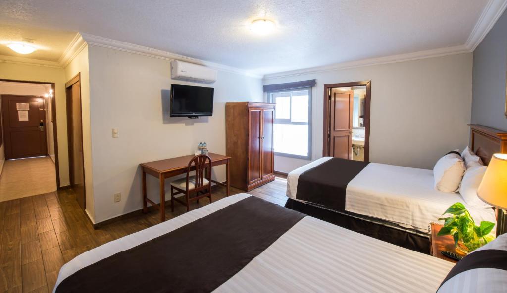 Postel nebo postele na pokoji v ubytování Del Marques Hotel and Suites