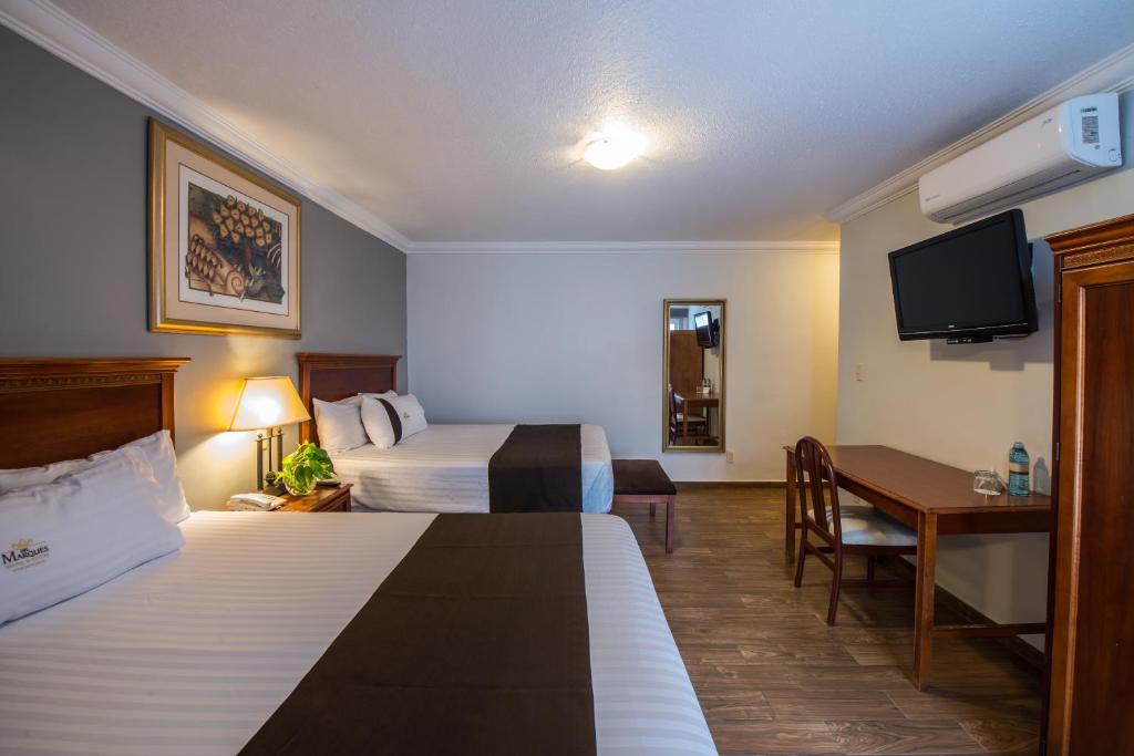 Postel nebo postele na pokoji v ubytování Del Marques Hotel and Suites