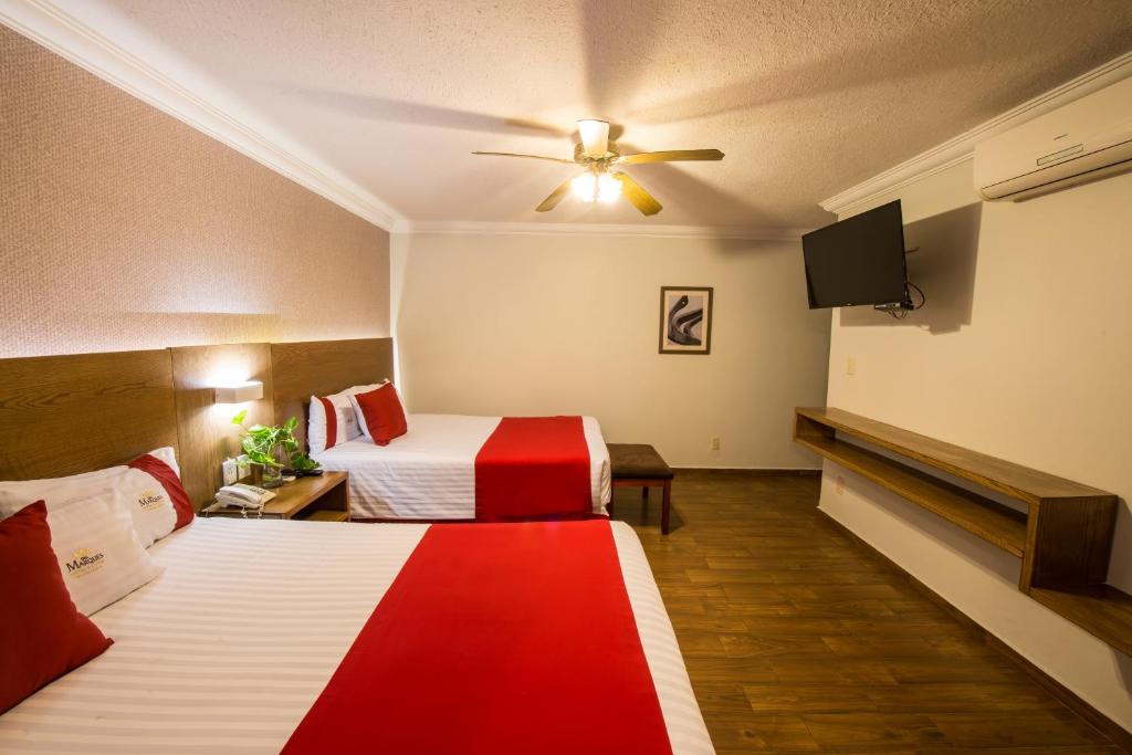 Postel nebo postele na pokoji v ubytování Del Marques Hotel and Suites